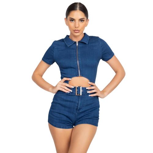 Front view of a model wearing a dark blue belted zip-up denim romper with a waist cutout.