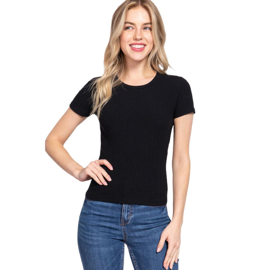 A model wears a classic black rib knit top with a crew neck and short sleeves, paired with blue denim jeans, ideal for a timeless and versatile look.