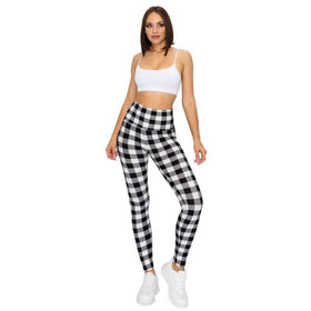 Woman in black and white plaid high-waist leggings paired with a white crop top, showcasing a sleek, modern look for yoga or casual wear.