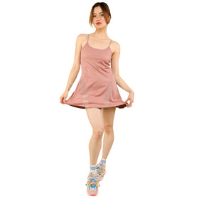 Front view of a woman in a dusty rose Mesh Detail Tennis Mini Active Dress with built-in shorts. The dress has a fitted bodice, thin shoulder straps, and mesh side panels, perfect for active and casual wear.