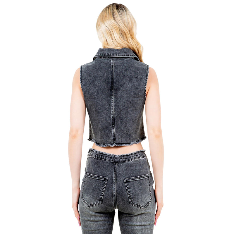 Load image into Gallery viewer, Back view of the black washed denim vest, emphasizing the raw hemline and fitted silhouette. The matching black denim pants complete the coordinated look.
