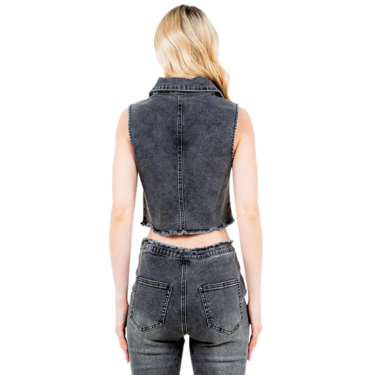 Back view of the black washed denim vest, emphasizing the raw hemline and fitted silhouette. The matching black denim pants complete the coordinated look.