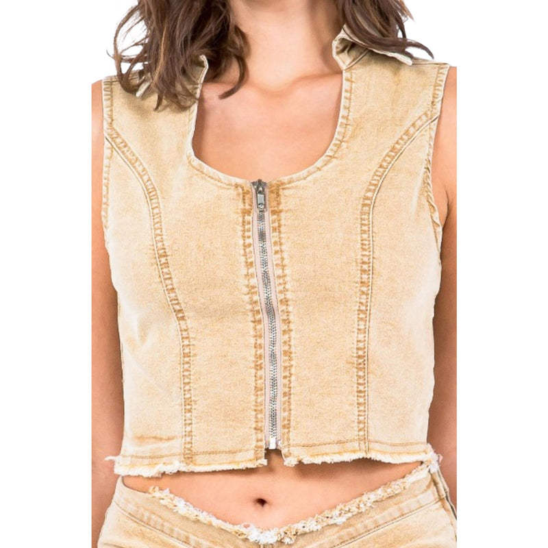 Load image into Gallery viewer, Close-up image of a beige cropped denim vest with a front zipper and frayed hem detailing, showcasing the structured seams and raw finish.
