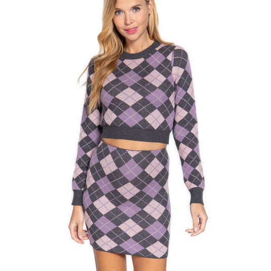 Close-up front view of a Charcoal and Pink Argyle Jacquard Sweater Mini Skirt on a model, emphasizing the detailed knit pattern and mini length.