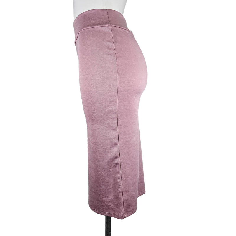 Load image into Gallery viewer, Side view of a coral high-waisted pencil skirt displayed on a mannequin, highlighting the sleek silhouette and the mid-calf hemline.
