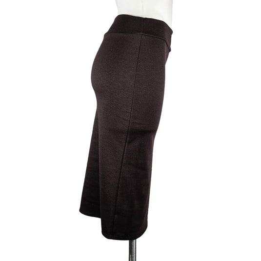 Alternate side view of a mocha high-waisted pencil skirt on a mannequin, focusing on the contoured waist and the sophisticated mid-length cut.