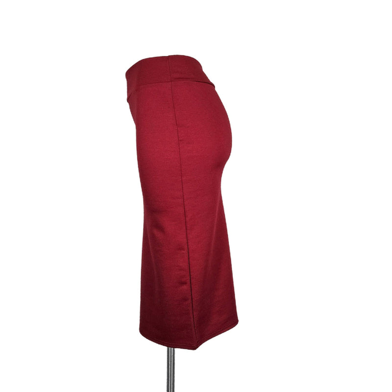Load image into Gallery viewer, Side view of a red high-waisted pencil skirt on a mannequin, showing the skirt&#39;s elegant line and form-flattering silhouette.
