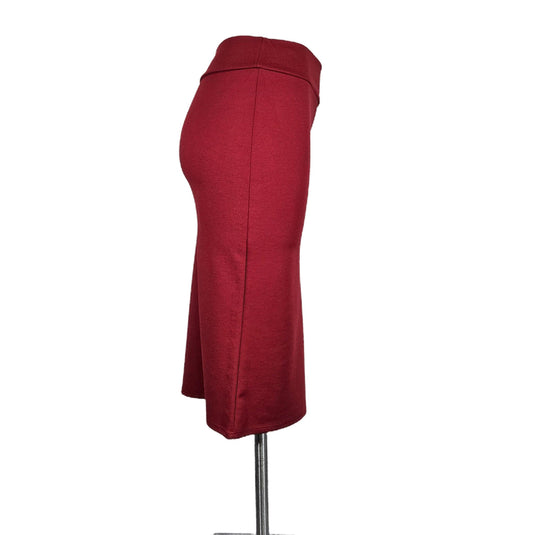 Alternate side view of a red high-waisted pencil skirt on a mannequin, illustrating the skirt's structured waistband and mid-calf hemline.