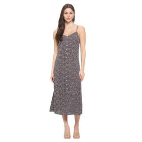 Front view of a mid-length black floral maxi dress with spaghetti straps and a straight neckline, paired with clear heeled sandals.