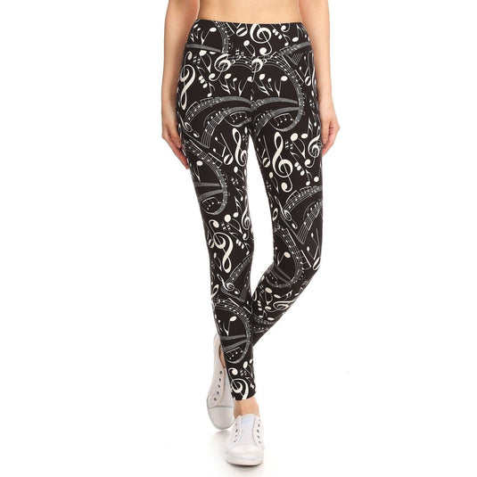 Front view of black and white music note print yoga leggings, paired with white sneakers, showcasing a high-waisted fit and vibrant design for the musically-inspired fashion enthusiast.