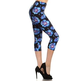 Vibrant blue floral capri leggings featuring a high-waist fit, providing both comfort and style, paired with elegant black heels.