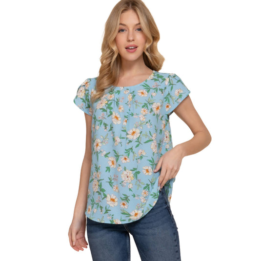 Elegant model wearing a light blue floral top with short tulip sleeves, showcasing a round neck and a comfortable fit.