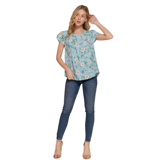 Full-body shot of a woman in a serene blue floral woven top paired with slim-fitting jeans, exuding casual elegance.