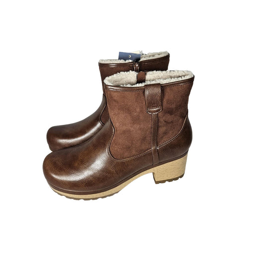 Angled side view of brown clog boots with sherpa lining, showing the zippered closure and the contrast of materials.