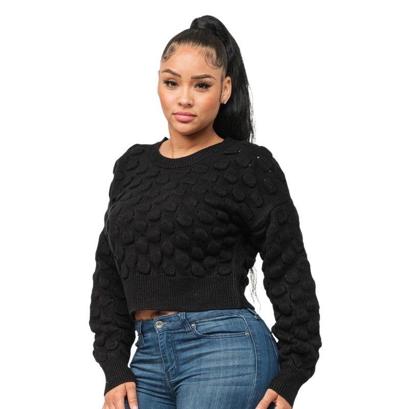 Load image into Gallery viewer, Three-quarter view of a fashionable black puffy checker knit sweater paired with classic blue jeans on a woman.
