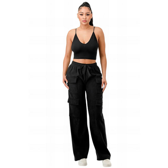 Fashion-forward model in classic black corduroy cargo pants and a sleek black sports bra, showcasing a monochrome outfit for modern street style.