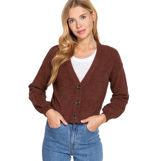 Woman in brown cardigan and jeans for a casual look.