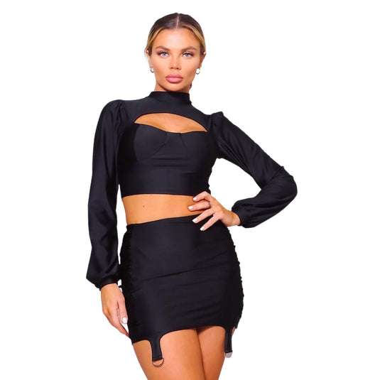 Chic black cutout turtleneck blouse paired with a figure-hugging ruched skirt set, showcasing a bold yet sophisticated look perfect for evening events.