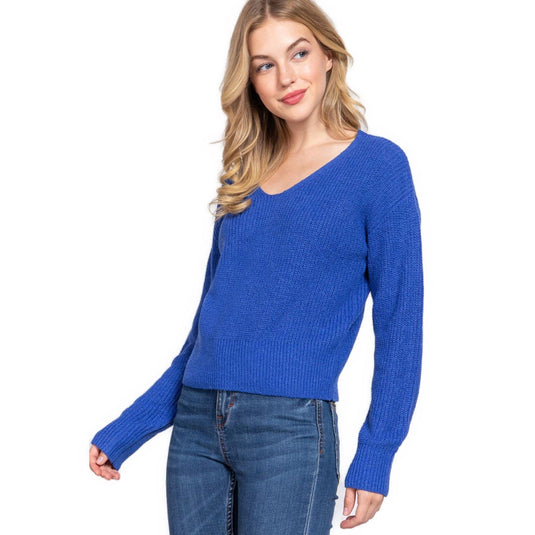 Close-up of a woman sporting a vibrant blue V-neck sweater, ideal for a chic casual outfit.