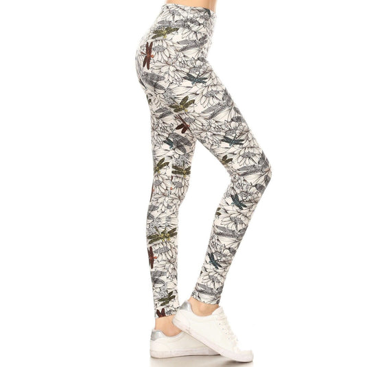 Side view of leggings adorned with a delicate dragonfly and floral pattern in gray and white, matched with crisp white athletic shoes.