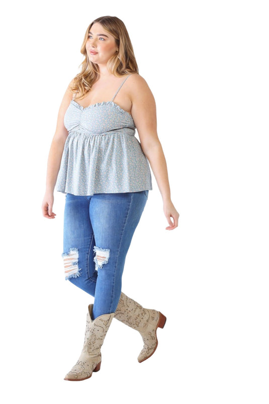 Back view of a plus-size model in a blue floral smocked cami, focusing on the smocked back detail and relaxed, flowy silhouette.