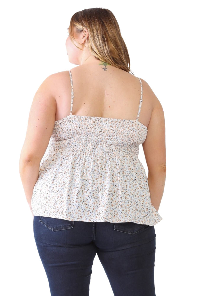 Load image into Gallery viewer, Back view of a plus-size model in a floral smocked sweetheart neck cami, highlighting the smocked back and flowy peplum design.
