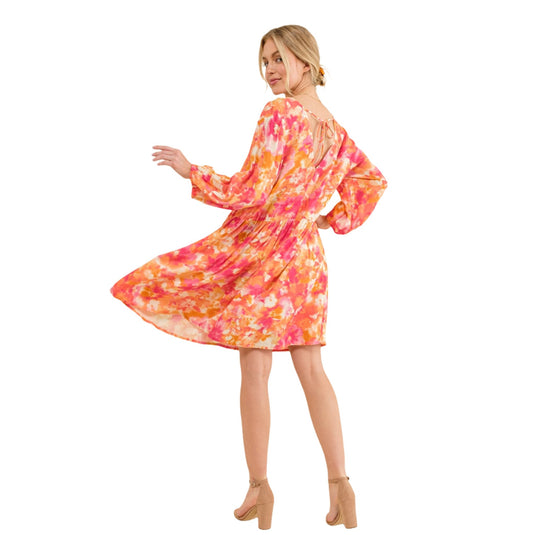 Back view of a woman twirling in a floral V-neck dress with puff sleeves, showcasing the dress's loose and comfortable fit.