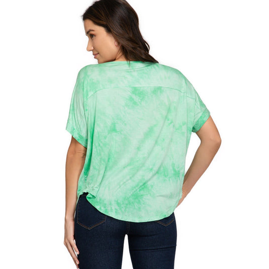 Backside of a light green tie-dye V-neck top highlighting a loose drop shoulder cut, seamlessly blending comfort with contemporary style.