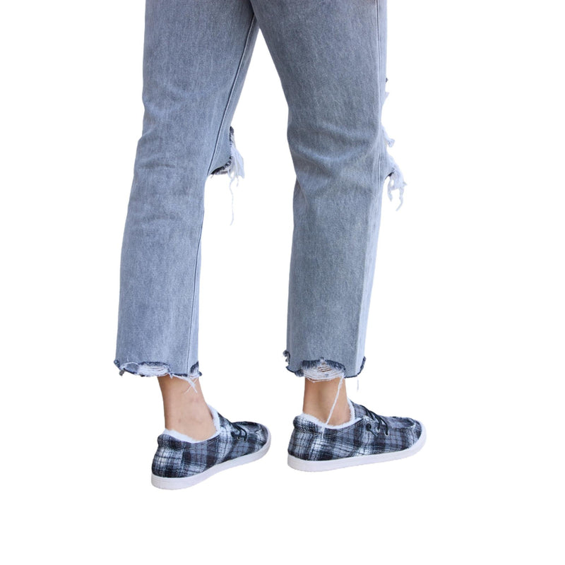 Load image into Gallery viewer, Back view of gray distressed jeans paired with plaid plush sneakers.
