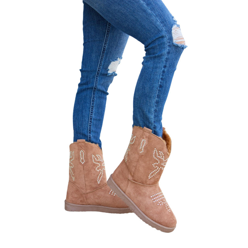 Load image into Gallery viewer, Brown flat boots with rhinestone detailing and plush fur, worn with distressed jeans.
