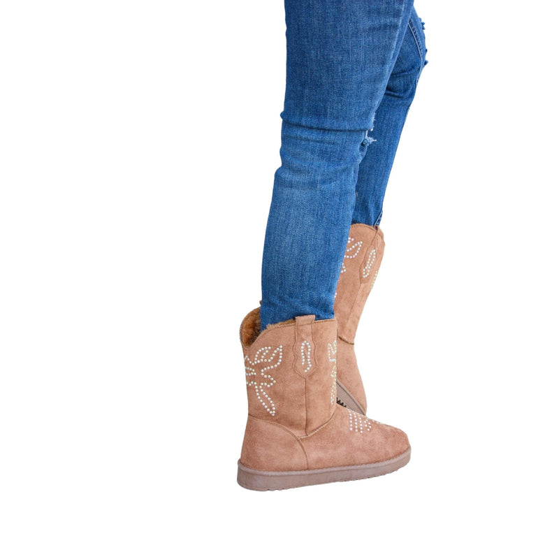 Load image into Gallery viewer, Woman stepping in brown rhinestone-studded flat boots with furry lining.
