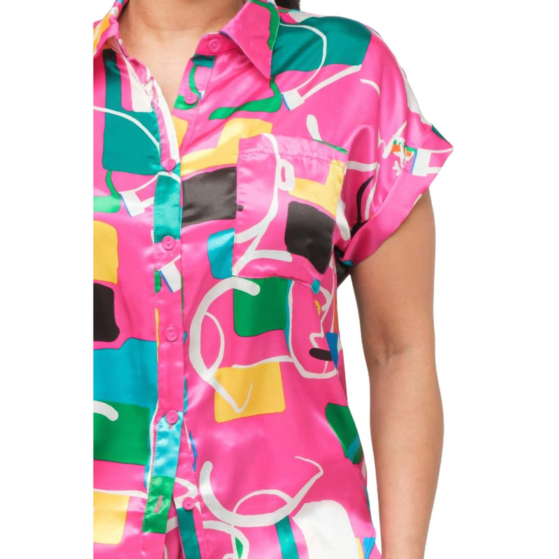 Load image into Gallery viewer, Close-up of a fuchsia satin top with abstract print, oversized fit and front pocket detail.
