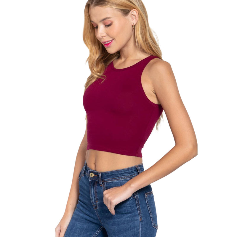 Load image into Gallery viewer, Close-up of a model in a burgundy crop top, demonstrating the top&#39;s fit and the versatility of pairing with high-waisted denim.
