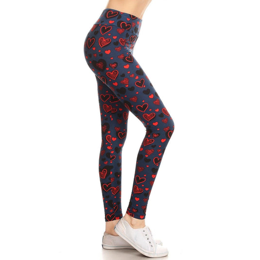 Side view of high-waisted navy leggings adorned with playful red and pink hearts, complemented by casual white lace-up sneakers.