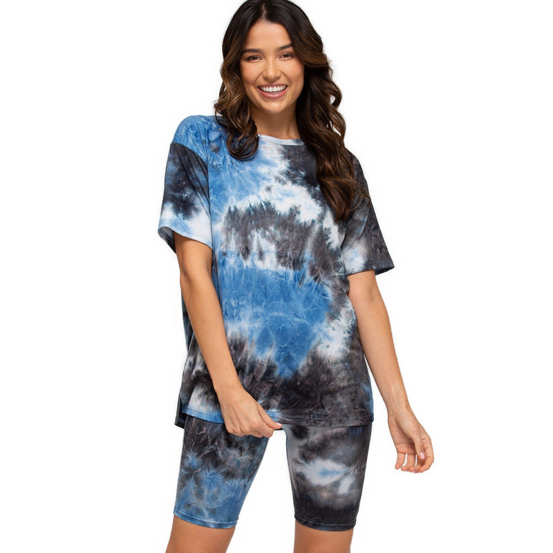 Load image into Gallery viewer, Smiling woman dressed in high-rise biker shorts featuring a stormy blue and grey tie-dye design, paired with a matching oversized tee.
