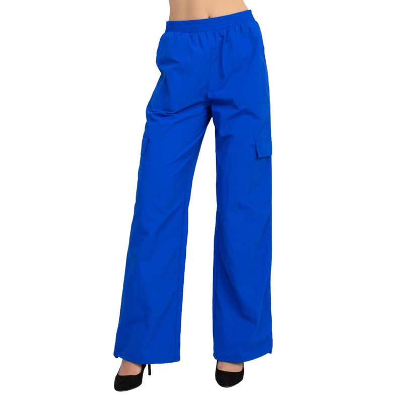 Load image into Gallery viewer, Close-up view of blue high rise cargo parachute pants, showing the relaxed fit and elastic waistband.
