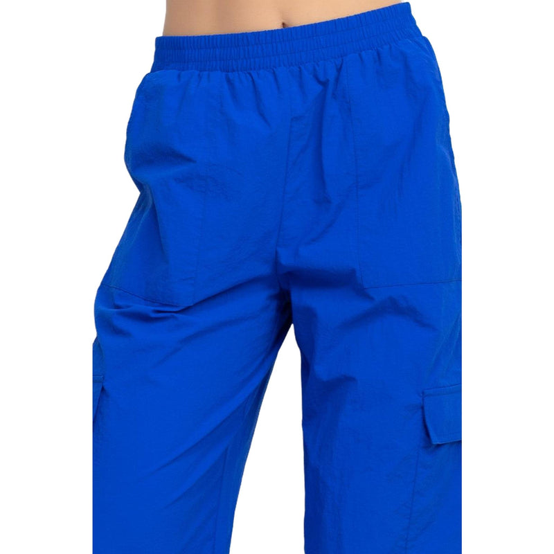 Load image into Gallery viewer, Detailed shot of the blue high rise cargo parachute pants&#39; waist area, showcasing the elastic band.
