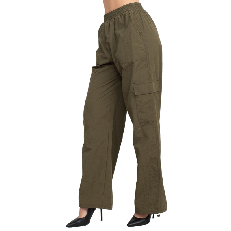 Load image into Gallery viewer, Side view of olive green high-rise cargo parachute pants with an elastic waistband. The pants feature a relaxed fit and multiple pockets, ideal for a casual and functional style.
