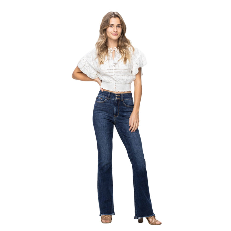 Load image into Gallery viewer, Model wearing Judy Blue Frayed Hem Bootcut Denim Jeans paired with a white top, showcasing the versatile and flattering fit.
