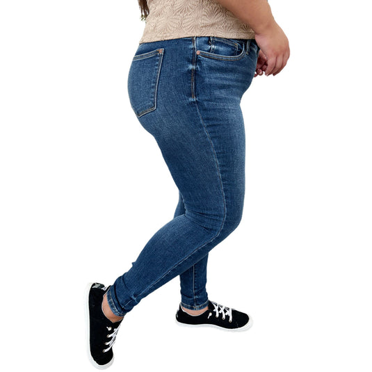 Side angle of Judy Blue Full Size Handsand Skinny Jeans, highlighting the medium wash and stylish fit on a curvy figure.