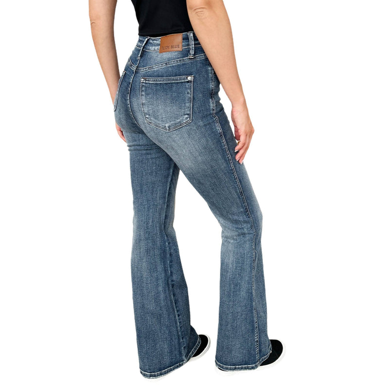 Load image into Gallery viewer, Back angled view of Judy Blue High Waist Tummy Control Flare Jeans, highlighting the curve-enhancing fit and flare leg style.
