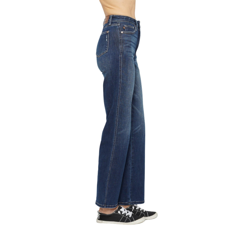 Load image into Gallery viewer, Side profile of dark wash Judy Blue High Waist Tummy Control Jeans with black sneakers.
