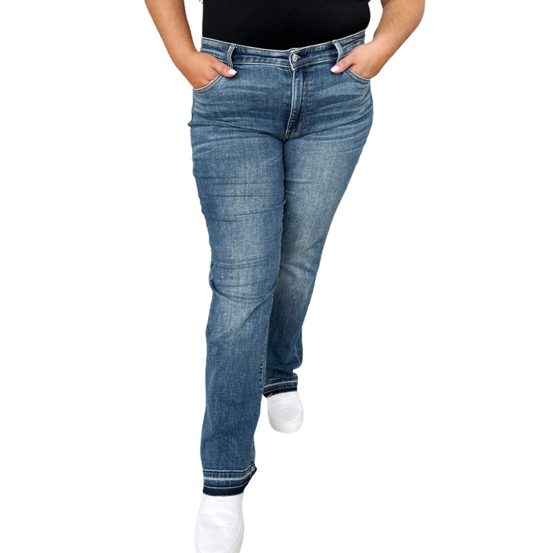 Load image into Gallery viewer, Front view of a woman wearing Judy Blue Full Size Mid Rise Release Hem Jeans, paired with a black tank top, perfect for casual wear.
