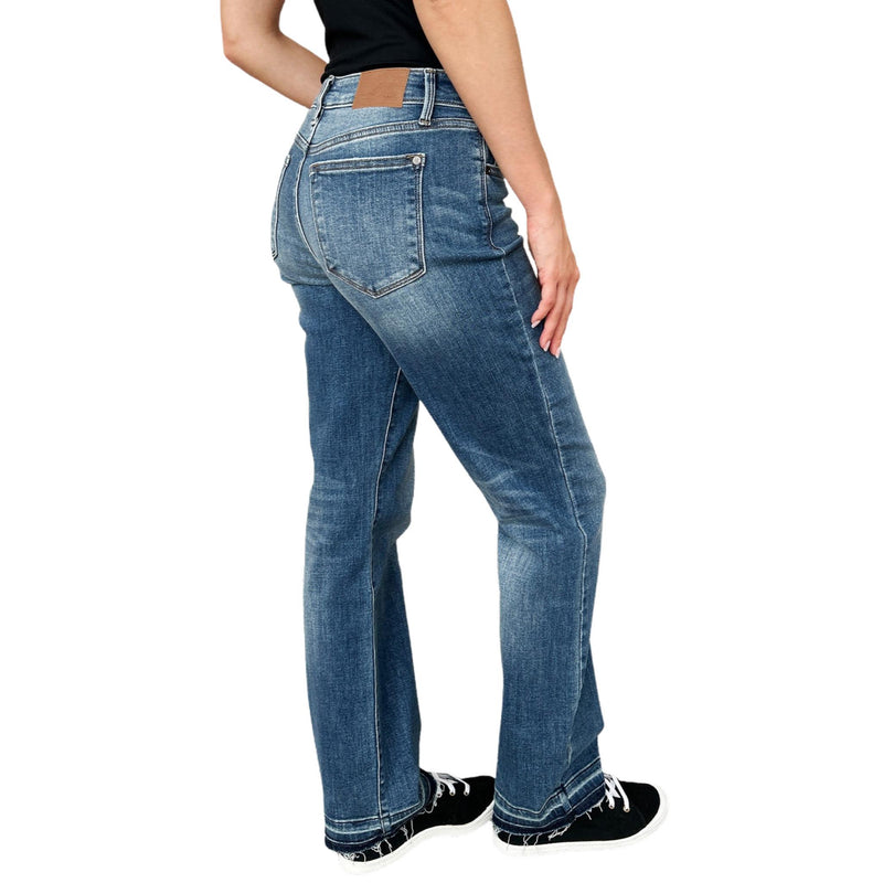 Load image into Gallery viewer, Full body shot of a woman walking in Judy Blue Full Size Mid Rise Release Hem Jeans, emphasizing the slim fit and stylish hem.
