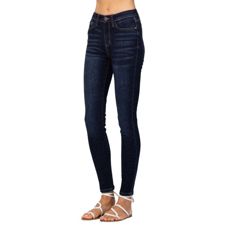 Load image into Gallery viewer, Close-up of Classic High Waist Skinny Jeans in dark wash, showing the high waist design and sleek skinny fit.
