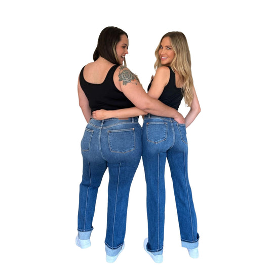 Two women posing back-to-back while wearing the High Waist Front Seam Detail Straight Jeans, displaying the flattering back pockets and streamlined fit on both body types.