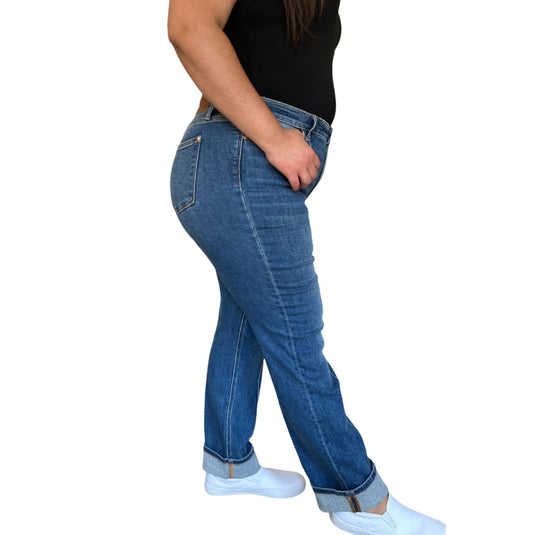 A side view of a woman wearing the High Waist Front Seam Detail Straight Jeans, highlighting the comfortable fit around the hips and thighs, paired with a black top and white sneakers.