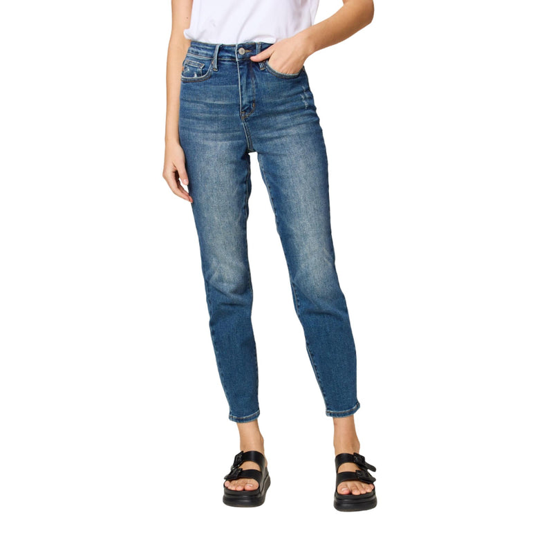 Load image into Gallery viewer, The model stands with feet slightly apart, highlighting the fit and details of the blue high-waisted jeans with a relaxed ankle length.
