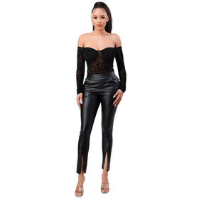 Full-body view of a model in a black, off-the-shoulder leopard print bodysuit with long sleeves and a sweetheart neckline. She is wearing black leather pants with a front slit and open-toe heels. The model stands confidently, with her hands by her sides.