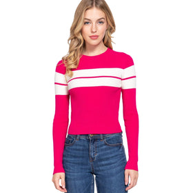 Confident young woman showcasing a vibrant pink ribbed sweater with two horizontal white stripes on the chest.